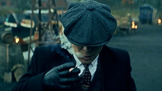 Tommy Shelby lighting a cigar, embodying his iconic Peaky Blinders style