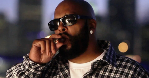 Suge Knight smoking a cigar exuding a powerful and confident presence