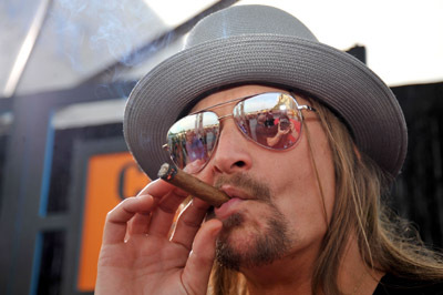 Kid Rock enjoying a premium cigar, embodying the rockstar lifestyle